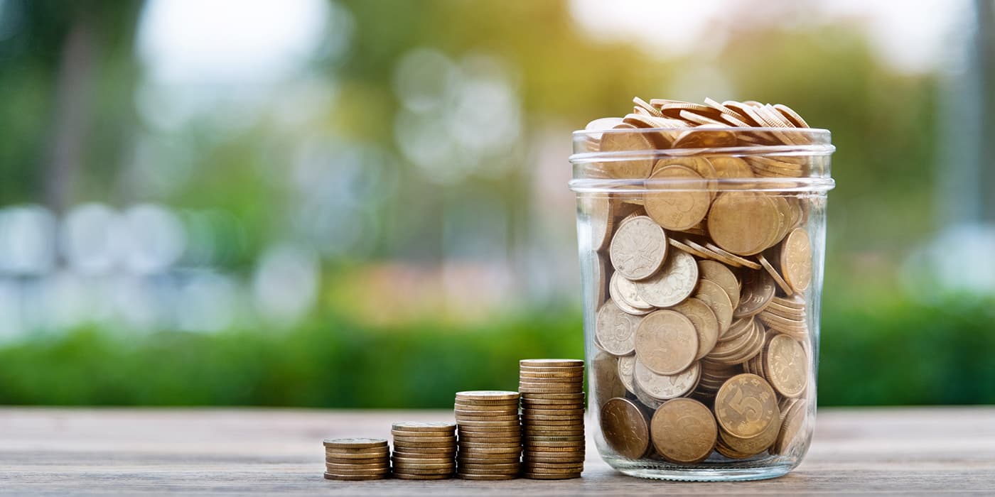 A glass jar full of coins.